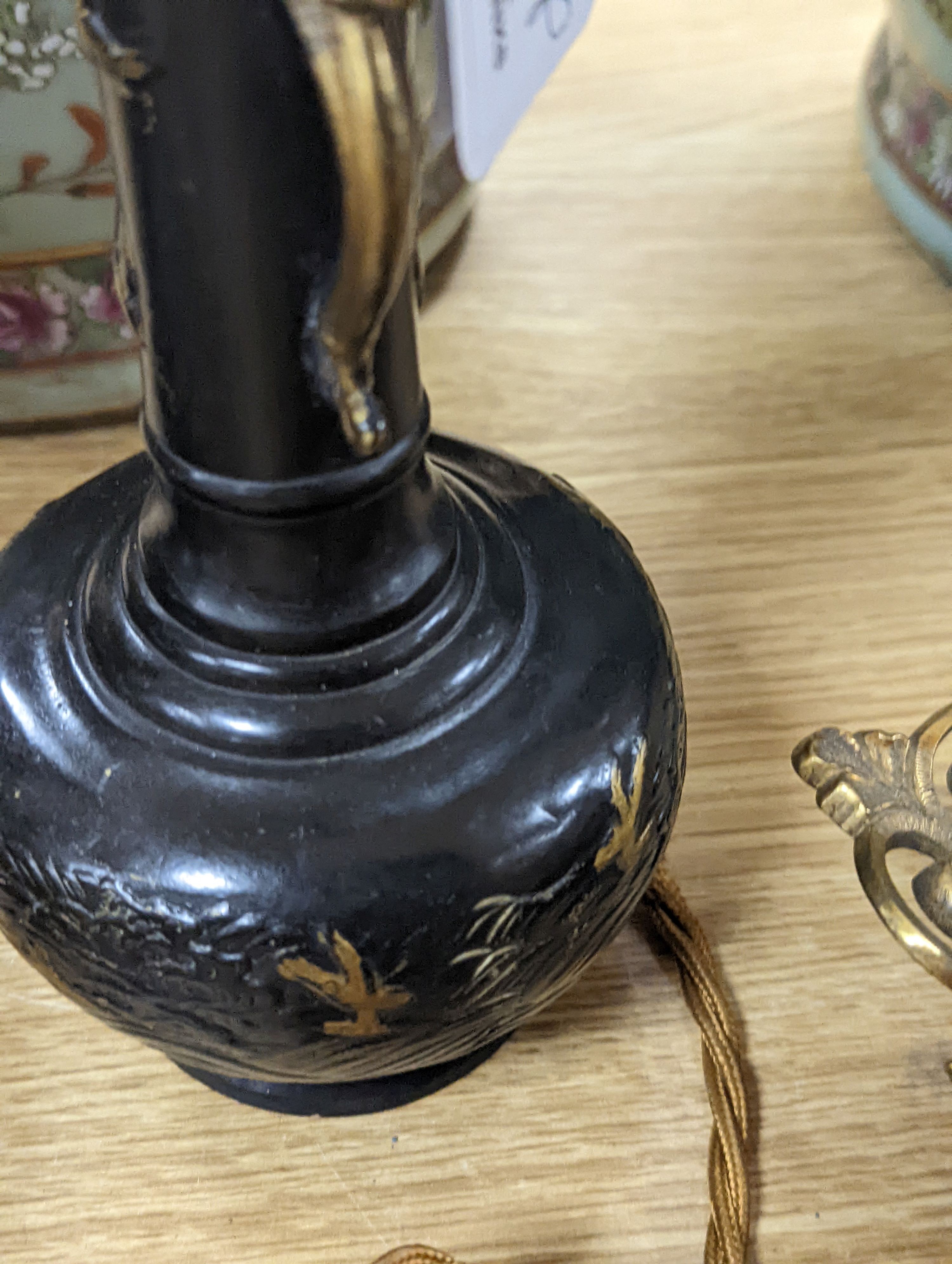 A decorative scroll brass inkstand, together with a pair of lamps, 29cm tall, (3)